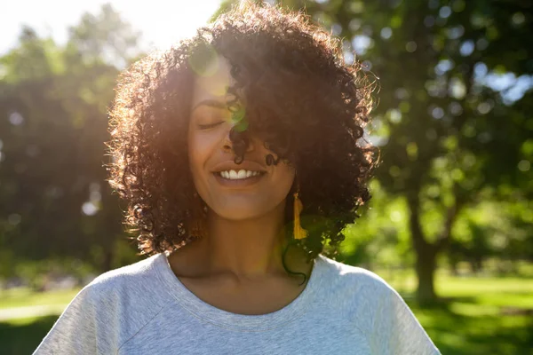 Mujer Joven Sonriendo Girando Cabello Rizado Mientras Está Pie Afuera — Foto de Stock