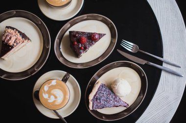 Dilim kek. Dilim çikolatalı pasta tabağı üzerinde. Sıcak çikolata kakao (kahve) bardak içki. Siyah arka plan.