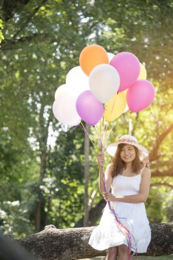 yaz tatili, kutlama ve yaşam tarzı kavramı - renkli balonlar açık parkta güzel bir kadınla.