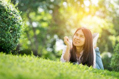 Yüz parkta gülümseyen genç güzel kadın rahat. İşten sonra dinlenmek için zaman. Horizontal.Blurred Background.Film etkisi.