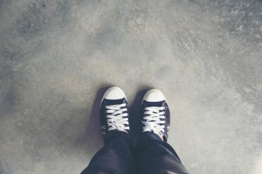 Hayat bir yolculuktur, çimenlerin üzerindeki siyah spor ayakkabı. Seyahat Konsepti. Genç gezginler için siyah spor ayakkabılar. Genç neslin yaşam tarzını rahatlatmak kolay..