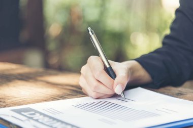 Beautiful business woman using pen signing on new contract to starting projects.  working woman work outdoor. business concepts.