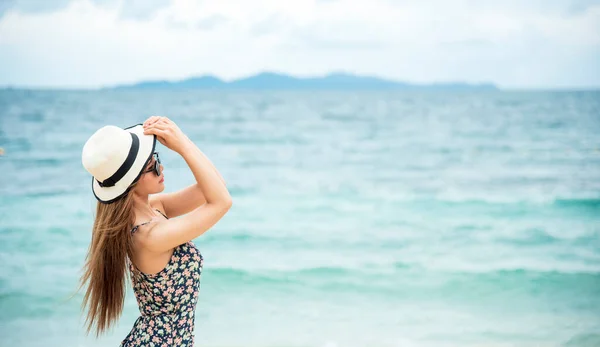 Summer bikini woman vacation on the tropical paradise beach. Cheerful woman wear red sexy bikini walking on beach. Time to relax in summer lifestyle outdoor shot on tropical island beach.