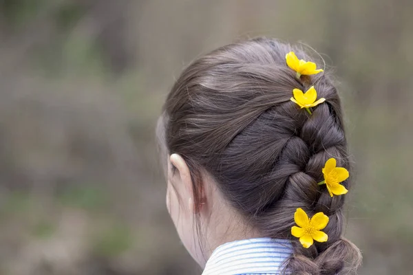 Woman with braided hair and flowers in her hair
