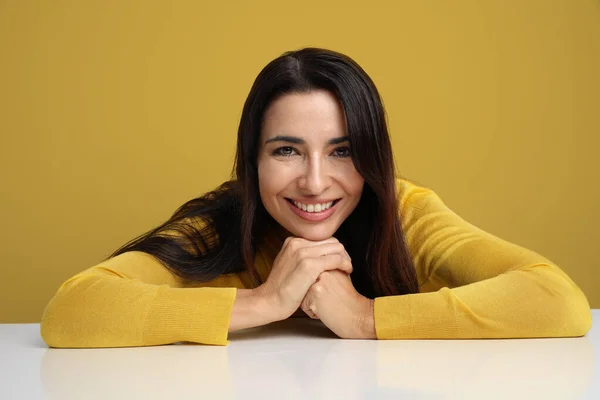 Giovane donna sorridente e in posa sullo sfondo giallo . — Foto Stock