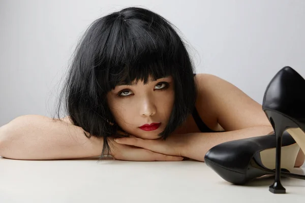 Front view of young Chinese woman with short hair posing on the white background. Isolated. — ストック写真