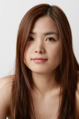 Asyalı genç bir kadının dikey portresi. Güzellik konsepti. 