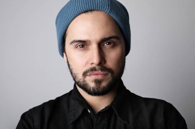 Yakışıklı ve sakallı hippi kafasına şık bir şapka takıyor. Bıyıklı ve sakallı, sakalsız, vahşi bir adam..