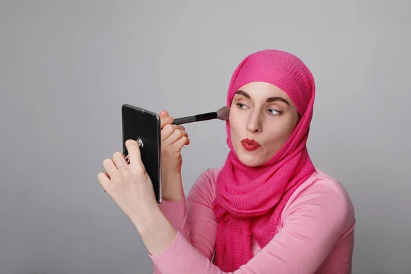 Close-up portrait of charming Muslim woman doing make-up. Horizontal. — Stock Photo, Image