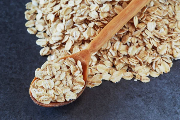 Oat flakes in a spoon — Stock Photo, Image