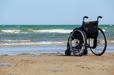 Tekerlekli sandalye kıyıda duruyor.