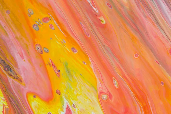 Abstract background of acrylic paint in red and yellow tones