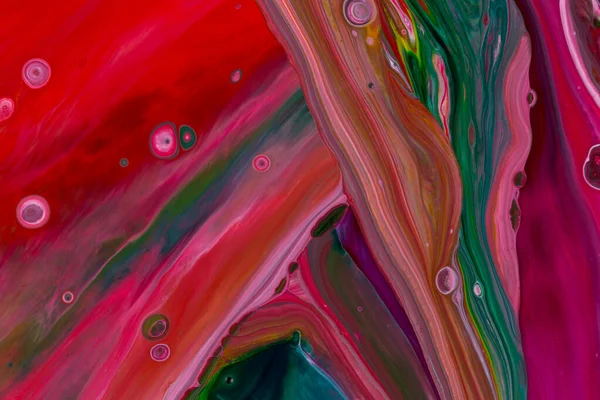 Abstract background of acrylic paint in red and green tones