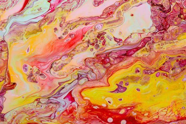 Abstract background of acrylic paint in red and yellow tones