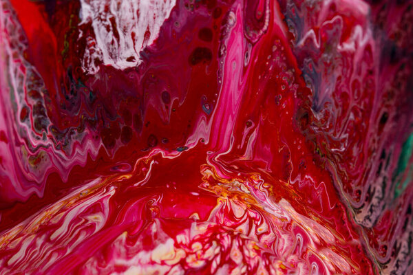 Abstract background of acrylic paint in red tones