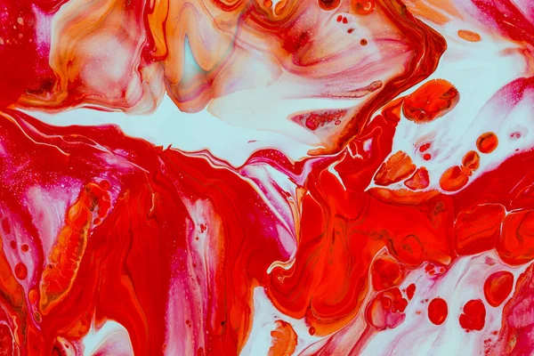 Abstract background of acrylic paint in red tones