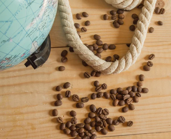 Happy day of conception Columbus. A globe, rope, coffee beans on wooden Board — Stock Photo, Image