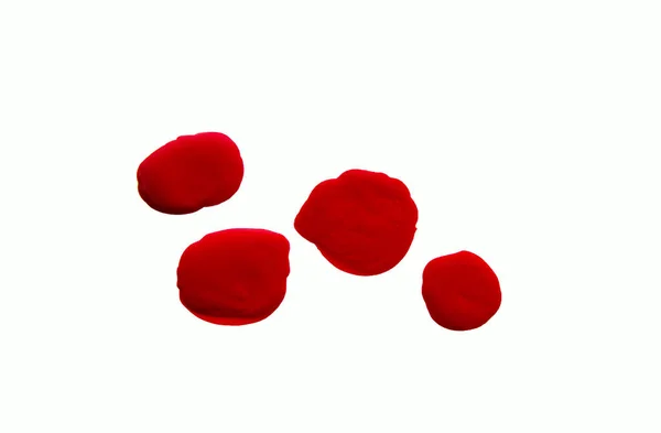 Gotas brilhantes de unha vermelha polonês isolado no fundo branco — Fotografia de Stock