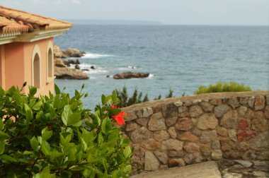 Beautiful view of the Bay in the Mediterranean sea on Palma, the Balearic Islands, part of the stone house and the fence,