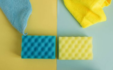 Mutfak ve banyo temizleme seti, sarı ve mavi süngerler ve paçavralar, bahar temizliği konsepti.