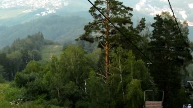 Resimli manzara, dağın tepesinden teleferikle, dağın eteğindeki şehirle, HD videosuyla açılır.