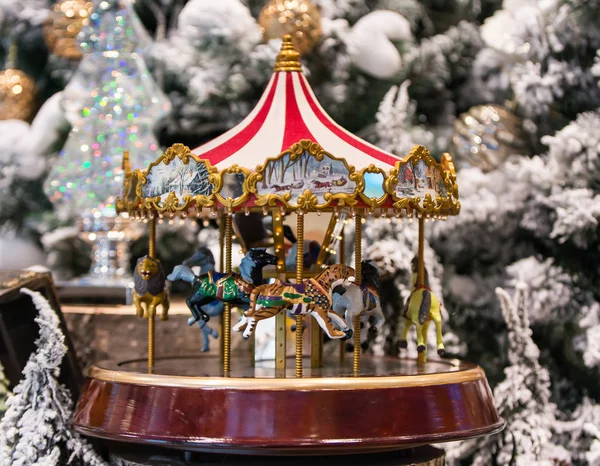 Christmas decoration carousel horses, Christmas presents on wooden table. — Stock Photo, Image