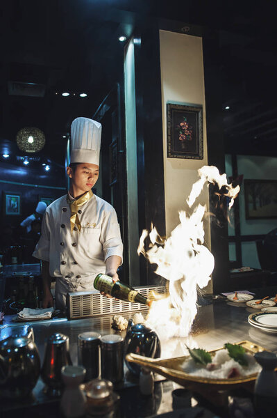 Asian chef doing Chinese cooking Stock Picture