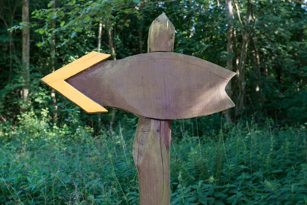 wooden arrow pointing left