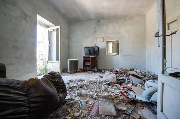 Room destroyed with furniture and old television