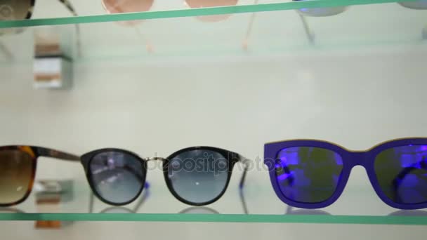 Cool blue glasses on the shelf — Stock Video