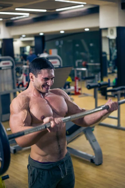 Sexy bodybuilder trains. fun in the gym. healthy lifestyle.