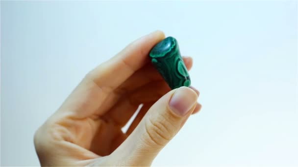 孔雀石是碳酸铜氢氧化矿物。手拿着绿色孔雀石 — 图库视频影像