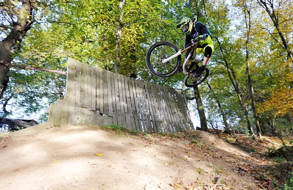 Biker jumping in a forest — Stock Photo, Image