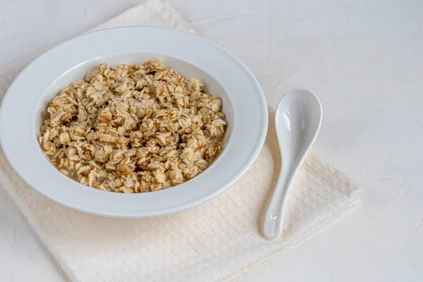 Breakfast consisting of oatmeal porridge. Healthy food, on a light gray background. — 스톡 사진