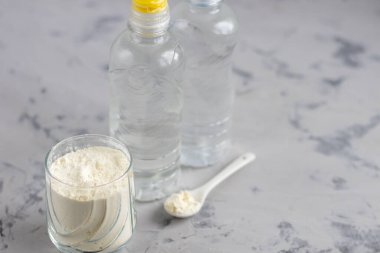 Kolajen tozu şeffaf bir kasede, ölçmek için bir kaşıkla birlikte. Fazladan protein alımı. Güzellik ve sağlık için doğal takviyeler. Kolajen bazlı bitki konsepti. Flatlay, üst manzara. Boşluğu kopyala