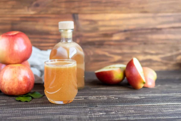Karanlık bir arka planda taze sıkılmış elma suyu. Faydalı vitamin, antiviral içecek. Boşluğu kopyala