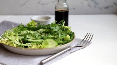 Taze salatalık, ıspanak yaprağı, roka, avokado. Dilimlenmiş yumurta ve kırmızı biberle servis ediliyor. Beslenme düzeni. Tüm aile için bir kahvaltı. Vitamin tabağı. Hafif bir arkaplanda.