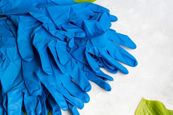 Disposable gloves for cleaning, and against the virus. On a gray background. Copy space.