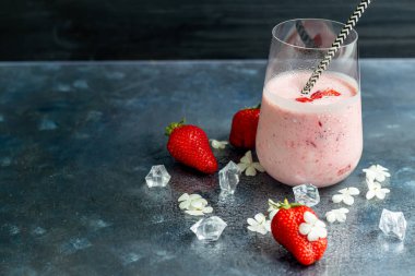 Koyu arkaplanda çilekli ve yoğurtlu meyve püresi. Sağlıklı beslenme, diyet. Boşluğu kopyala.