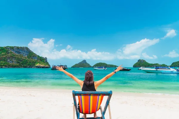 Happy woman traveler relaxing on beach chair joy fun beautiful n — Stok fotoğraf