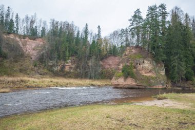 Nehir Amta, sonbahar, kırmızı kayalar, ahşap, Letonya. 2017