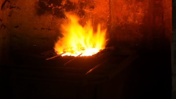 Ο σιδεράς παίρνει ένα θερμαινόμενο μεταλλικό αντικείμενο από τον κλίβανο — Αρχείο Βίντεο