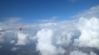 Bulutların üzerinde uçan bir uçağın kanadı.