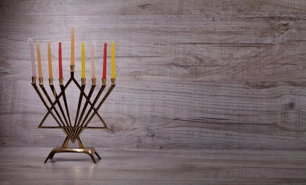 Jewish holiday Hanukkah. Menorah with candles on a light, wooden background. The concept of the Jewish holiday of Hanukkah. Front view
