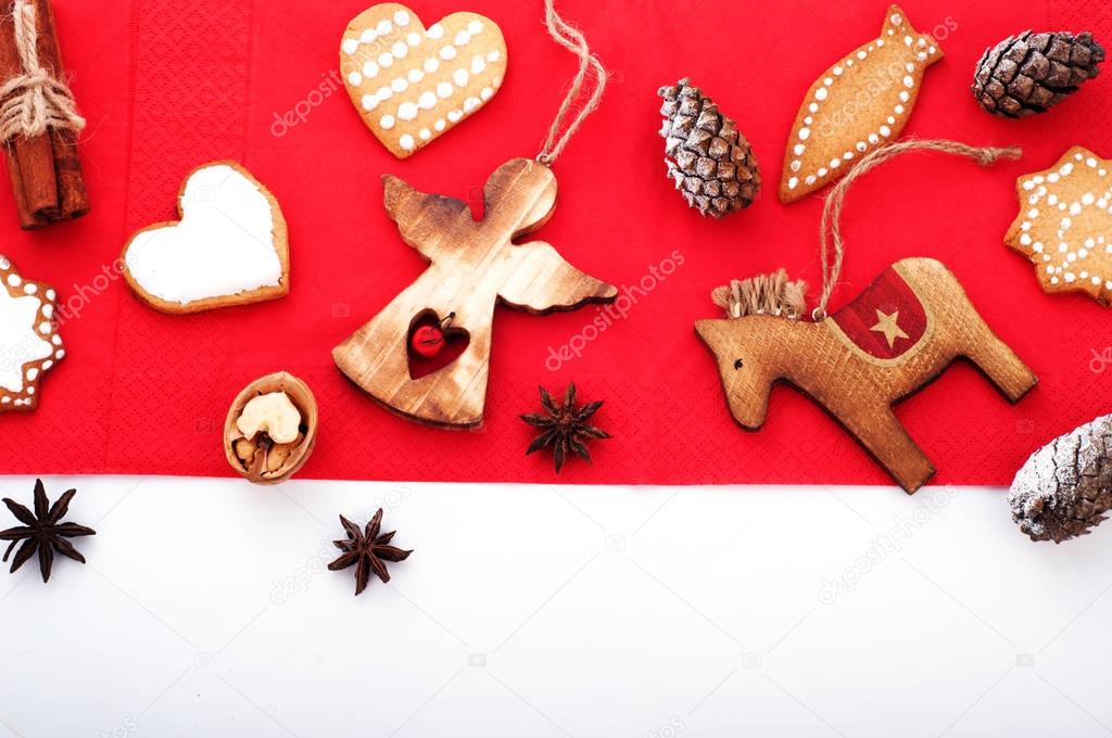 Christmas and New Year wallpaper (background).   Christmas tree decorations (sets) in the Scandinavian style, such as figure of an angel and horse, bumps, spices and herbs on white wooden background. Space for text