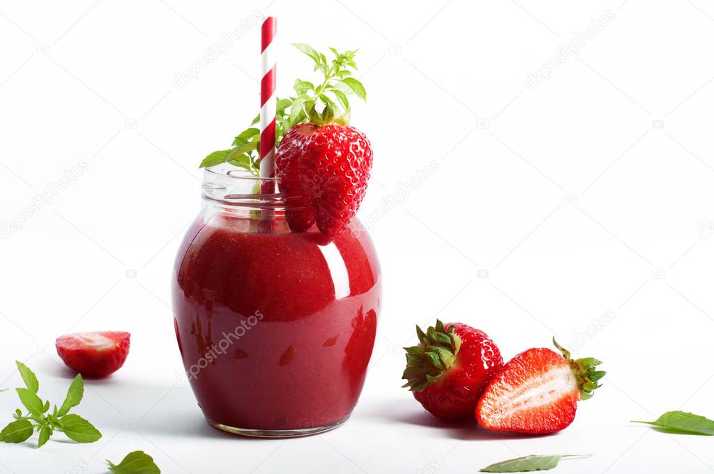 Strawberry (berry), a smoothie on a white background. Near strawberries and basil leaves. Vegetarian, vegan concept. Diet drink for detoxification. Space for text on a white background