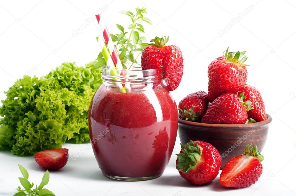 Strawberry (Berry), a smoothie on a white background. Near strawberries and lettuce leaves. Vegetarian, vegan concept. Diet drink for detoxification. Space for text on a white background