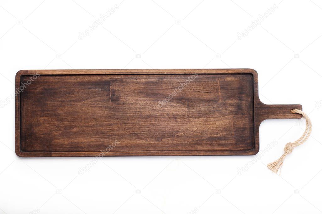 A long brown wooden cutting board that can be used for carrying food (tray), on a white background. View from above. Isolated object. Kitchen equipment for bars and cafes