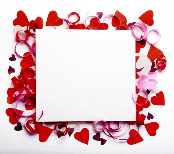 Creative layout made of colored paper hearts and a square scrap of paper placed in the center. Valentine with place for text. Celebration concept. — Stock Photo, Image