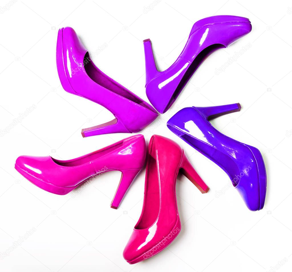 Bright high-heeled patent leather shoes are on a white background. Isolated objects